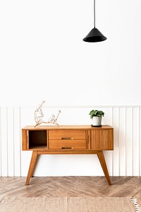 Pendant lamp over a wooden sideboard table 