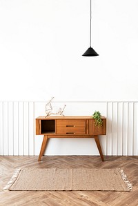 Pendant lamp over a wooden sideboard table 