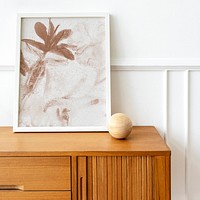 Picture frame mockup on a wooden sideboard table 