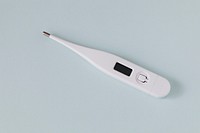 White digital thermometer on a gray background