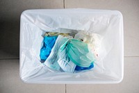 Used face masks in a contaminated waste bin
