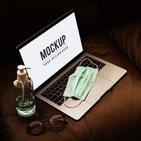 Medical mask on a laptop with a mockup screen