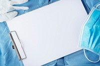 Paper clipboard on doctors scrubs