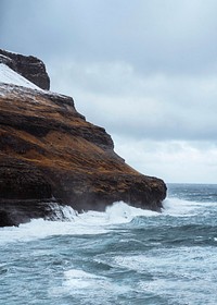 Stormy waves hitting the cliffs at Molin beach in Streymoy island, Faroe Islands