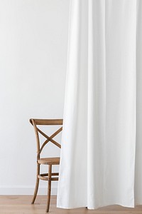 Vintage wooden chair behind a white curtain