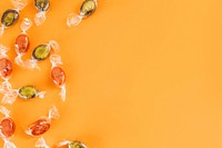 Candy on an orange background with copy space 