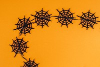 Spooky Halloween spider webs on an orange background design resource 