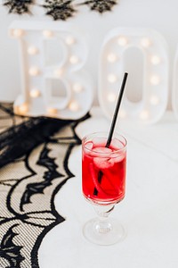 Halloween party decoration with a red drink in a glass 