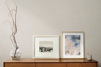 Picture frames on a wooden cabinet