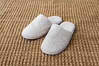 White indoor slippers on jute rug