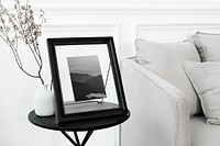 Minimal living room with tabletop picture frame on a side table 