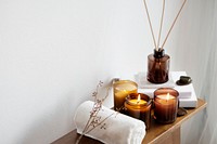 Aromatherapy table setting with scented candles and towel