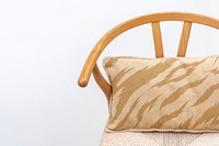 Minimal linen cushion cover in beige on a chair