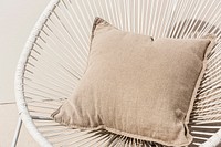 Beige printed cushion on a chair minimal interior design