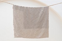 Plain beige towel hanging on a laundry rope