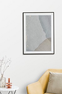 Picture frame with abstract art by a velvet armchair