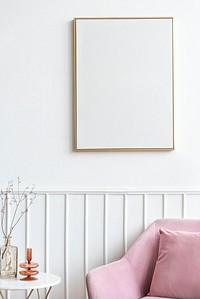 Blank picture frame by a pink velvet armchair