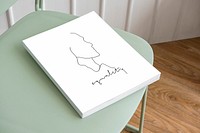 Book psd mockup on a pastel green chair