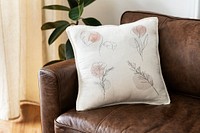 Cushion cover mockup psd on a leather couch