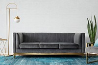 Chic mid-century modern luxury aesthetics living room with gray velvet couch and blue rug