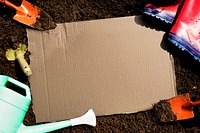 Blank cardboard on a garden soil