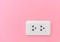 Electricity plug supply on pink wall