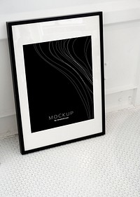 Black picture frame mockup on the floor