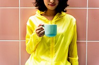 Woman is holding a coffee cup