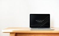 Laptop screen mockup on a wooden table