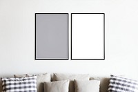 Two photo frames isolated on white wall