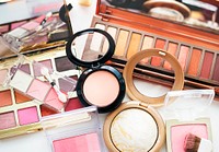 Various makeup products on white table