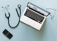 Aerial view of doctor stethoscope and computer laptop