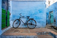 Bicycle leaning on the blue wall