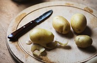 Potatoes peeled on a cutting board