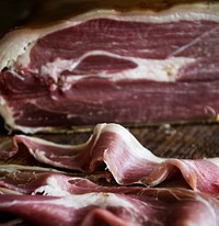 Closeup of dry-cured ham on a wooden table