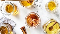 Food desktop wallpaper background, organic honey in a glass jar