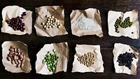 Various types of beans placed on brown paper