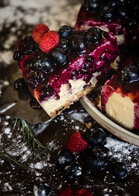 Closeup of a berry cheesecake with a slice cut out