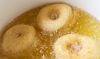 Donuts deep frying in a pot