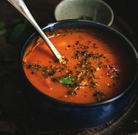 Homemade tomato soup in a black bowl