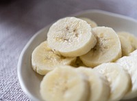 Close up of a plate filled with sliced bananas