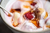 Yogurt bowl filled with raspberries and topped with honey