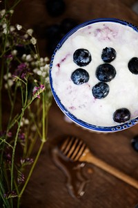 Bowl of yogurt sprinkled with blueberries