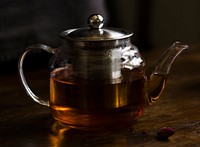 Teapot with hot tea on a table