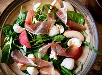 Spinach salad with parma ham and mozarella cheese food photography
