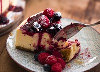 Slice of cheesecake topped with mixed berries sauce