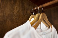 White clothes hanging in a wardrobe