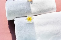 White towels decorated with plumeria flowers