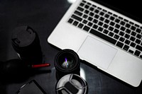 Closeup of a camera lens and a laptop