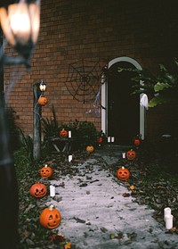 Halloween pumpkins and decorations outside a house